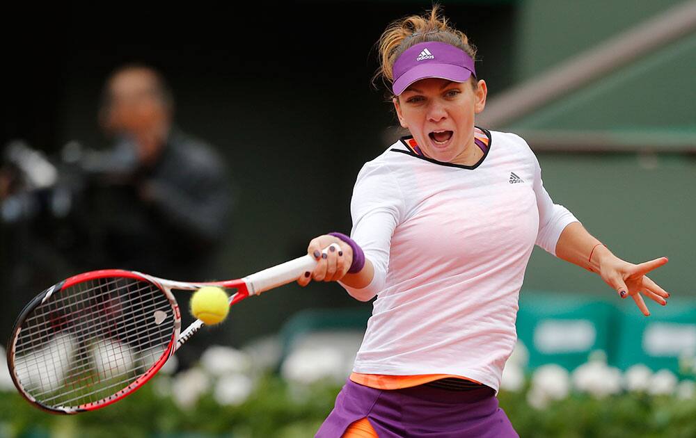 Romania's Simona Halep returns the ball to Russia's Alisa Kleybanova in the first round match of the French Open tennis tournament at the Roland Garros stadium, in Paris, France.