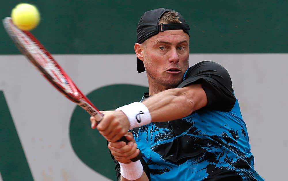 Australia's Leyton Hewitt returns the ball during the first round match of the French Open tennis tournament against Argentina's Carlos Berlocq at the Roland Garros stadium, in Paris, France. Berlocq won in four sets 3-6, 6-2, 6-1, 6-4.