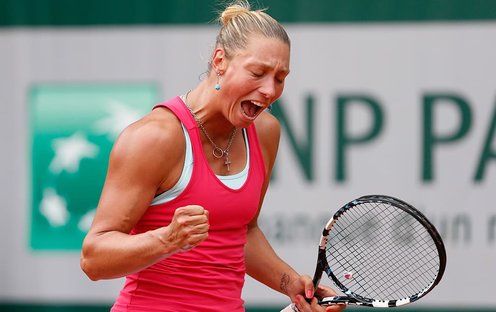 Belgium's Yanina Wickmayer celebrates scoring a point during the first round match of the French Open tennis tournament against Denmark's Caroline Wozniacki at the Roland Garros stadium, in Paris, France.