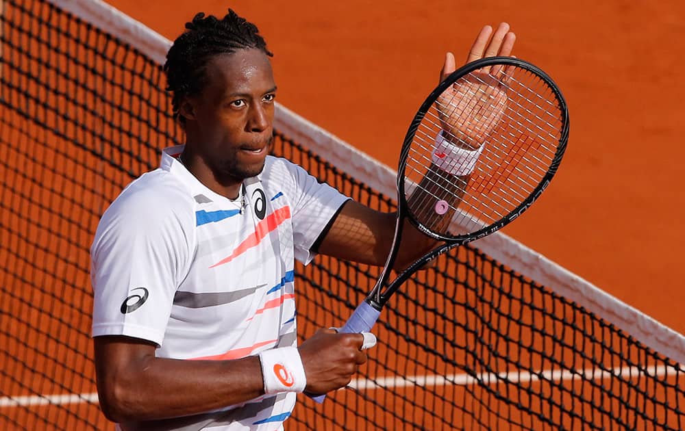 France's Gael Monfils celebrates winning the first round match of the French Open tennis tournament in four sets 6-2, 4-6, 6-4, 6-2, against Romania's Victor Hanescu at the Roland Garros stadium, in Paris, France.