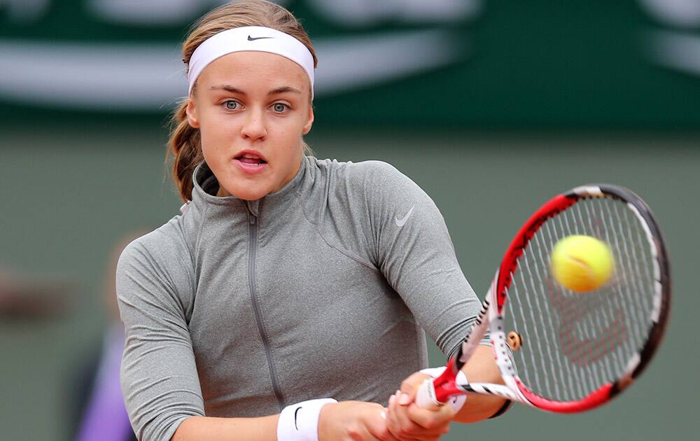 Slovakia's Anna Schmiedlova returns the ball to Venus Williams of the U.S. during the second round match of the French Open tennis tournament at the Roland Garros stadium, in Paris, France.