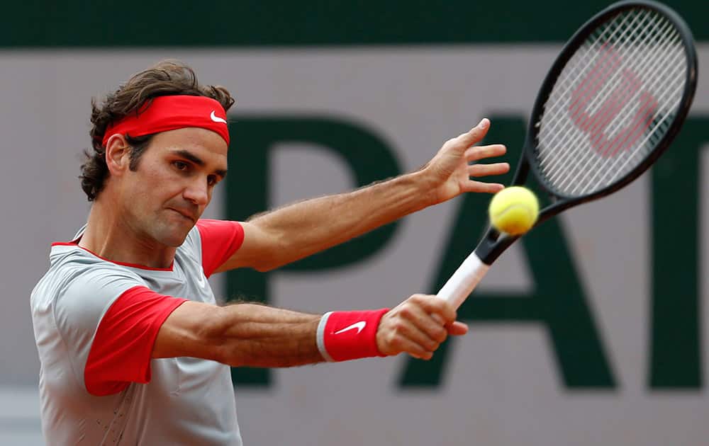 Switzerland's Roger Federer returns the ball during the second round match of the French Open tennis tournament against Argentina's Diego Sebastian Schwartzman at the Roland Garros stadium, in Paris, France.