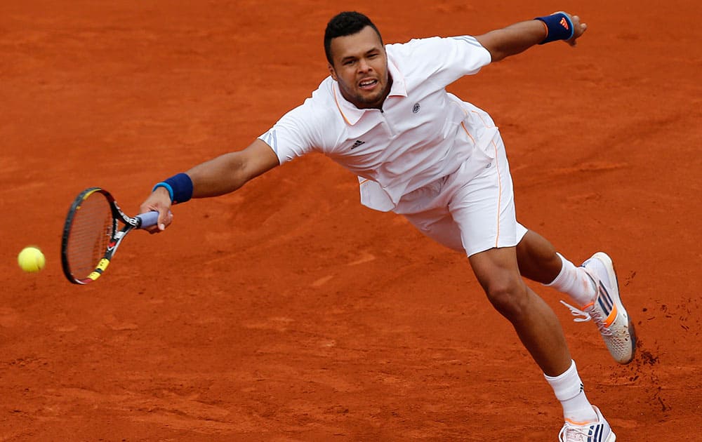 France's Jo-Wilfried Tsonga returns the ball to Austria's Jurgen Melzer during the second round match of the French Open tennis tournament at the Roland Garros stadium, in Paris.