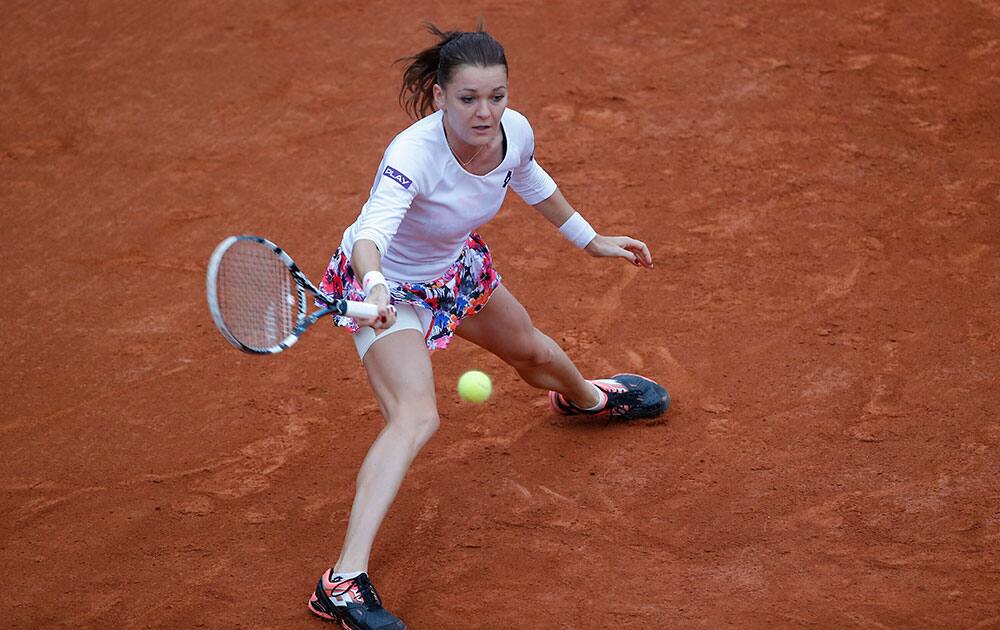 Poland's Agnieszka Radwanska returns the ball during the second round match of the French Open tennis tournament against Karolina Pliskova of the Czech Republic at the Roland Garros stadium, in Paris, France.