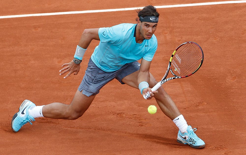 Spain's Rafael Nadal returns the ball during the second round match of the French Open tennis tournament against Austria's Dominic Thiem at the Roland Garros stadium, in Paris, France.