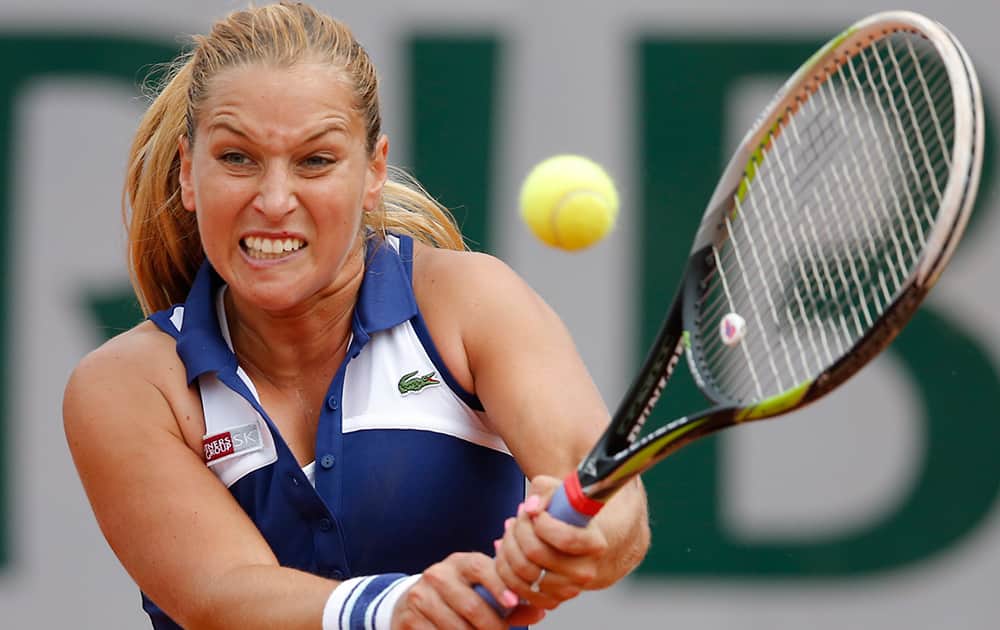 Slovakia's Dominika Cibulkova returns the ball to Australia's Samantha Stosur during the third round match of the French Open tennis tournament at the Roland Garros stadium, in Paris, France.