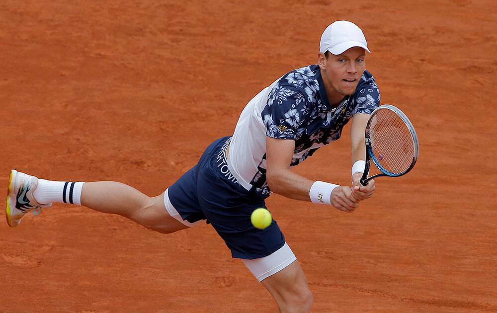 Tomas Berdych of the Czech Republic returns the ball during the fourth round match of the French Open tennis tournament against John Isner of the U.S. at the Roland Garros stadium, in Paris, France.