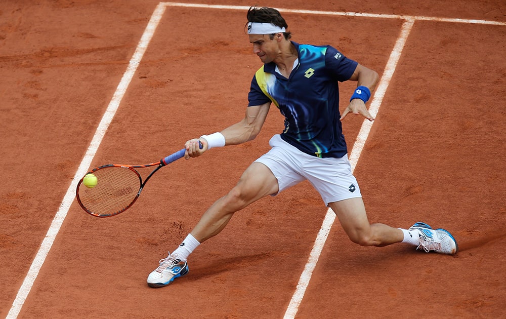 Spain's David Ferrer returns the ball during the fourth round match of the French Open tennis tournament against South Africa's Kevin Anderson at the Roland Garros stadium, in Paris, France.