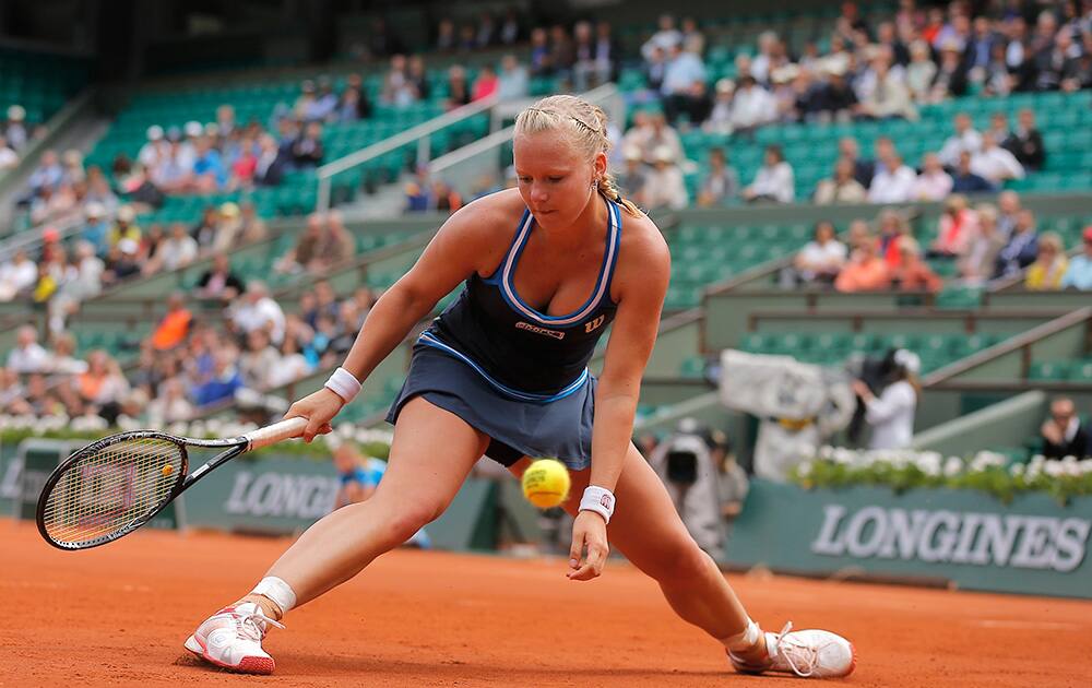 Netherlands' Kiki Bertens misses the ball as she plays Germany's Andrea Petkovic during their fourth round match of the French Open tennis tournament at the Roland Garros stadium, in Paris, France.