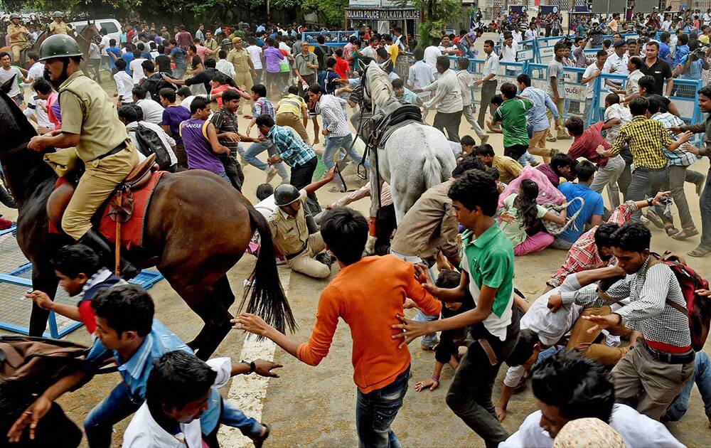 A horse-mounted police man evicting the mob from the front of Eden Garden during a felicitation programme of IPL winning Kolkata Knight Riders team, in Kolkata.