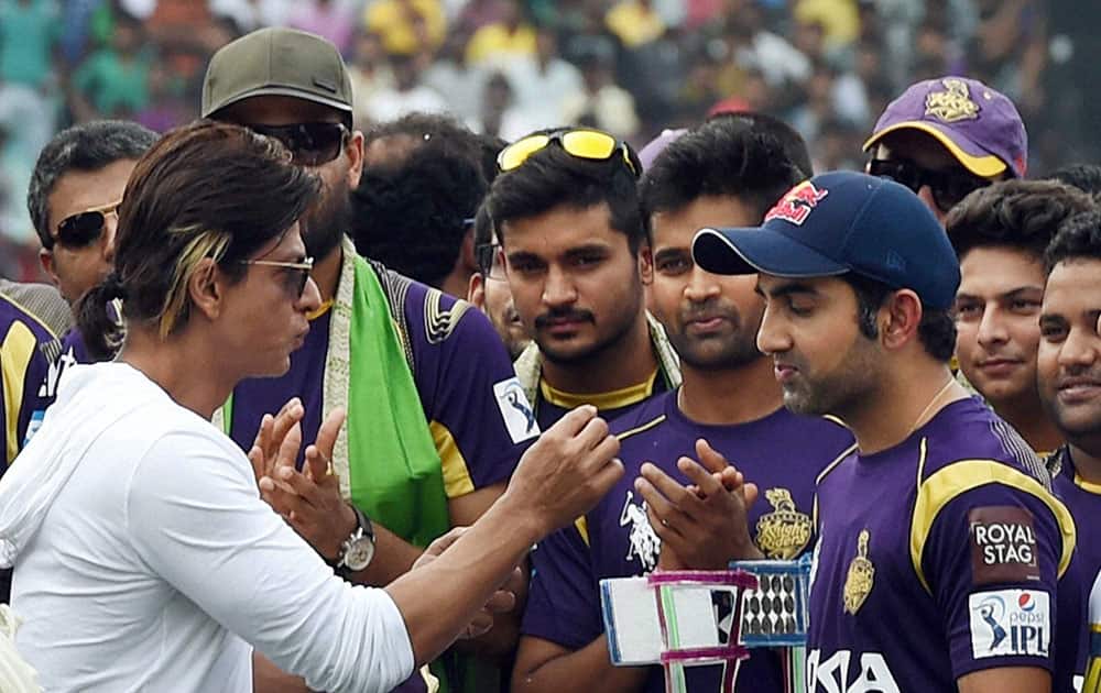 Kolkata Knight Riders owner Shahrukh Khan interacts with captain Gautam Gambhir and other players during a felicitaion ceremony for the team's victory at IPL - 7 tournament at Eden Garden in Kolkata