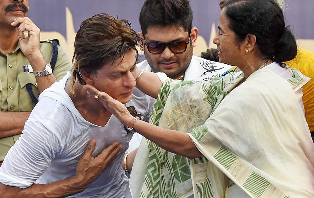 West Bengal Chief Minister Mamata Banerjee and Kolkata Knight Riders owner Shahrukh Khan during a felicitation ceremony for the team's victory at IPL - 7 tournament at Eden Garden in Kolkata