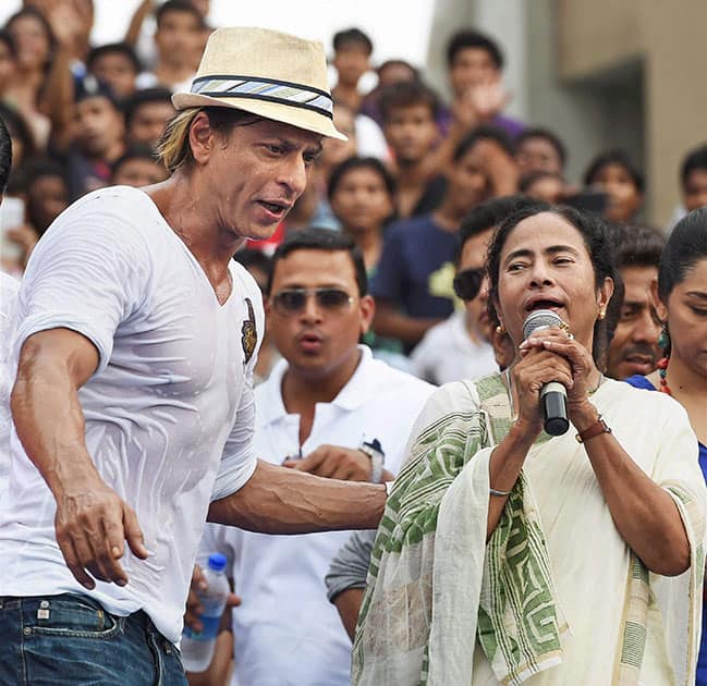 West Bengal Chief Minister Mamata Banerjee with Kolkata Knight Riders owner Shahrukh Khan during a felicitation ceremony for the team's victory at IPL - 7 tournament at Eden Garden in Kolkata