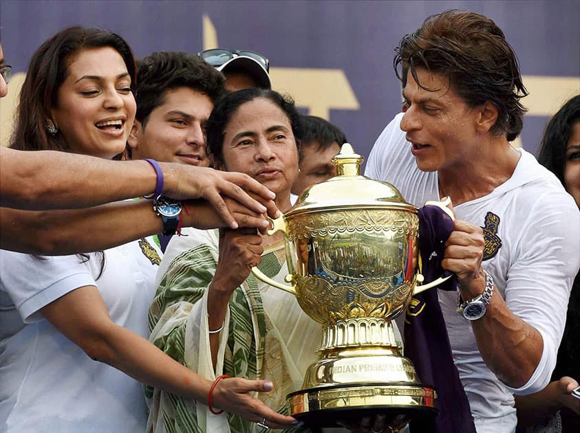 West Bengal Chief Minister Mamata Banerjee with Kolkata Knight Riders owners Shahrukh Khan and Juhi Chawla holding the trophy during a felicitation ceremony for the team's victory at IPL - 7 tournament at Eden Garden in Kolkata