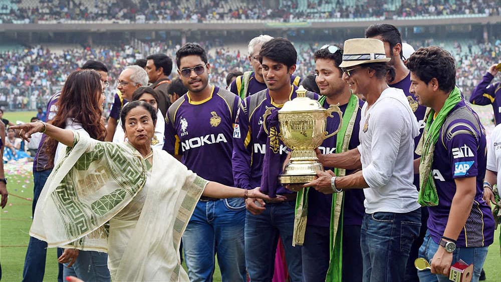 West Bengal Chief Minister Mamata Banerjee with Kolkata Knight Riders owner Shahrukh Khan and players during a felicitation ceremony for the team's victory at IPL - 7 tournament at Eden Garden in Kolkata.