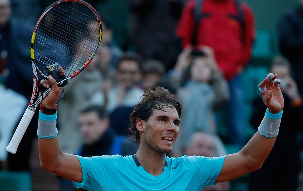 Spain's Rafael Nadal celebrates winning the quarterfinal match of the French Open tennis tournament against compatriot David Ferrer at the Roland Garros stadium, in Paris, France. Nadal won in four sets 4-6, 6-4, 6-0, 6-1.