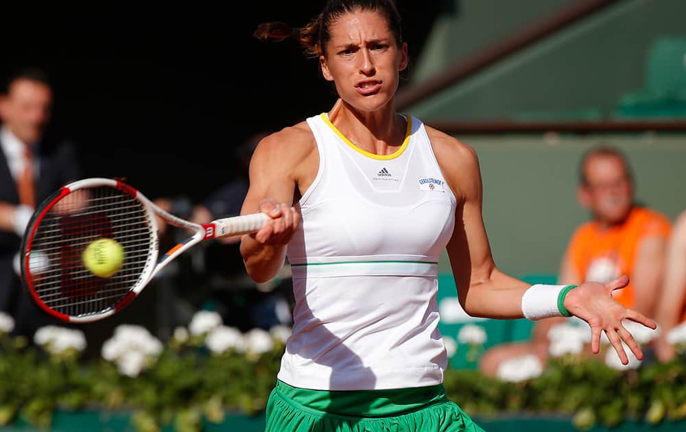Germany's Andrea Petkovic returns the ball to Romania's Simona Halep during their semifinal match of the French Open tennis tournament at the Roland Garros stadium, in Paris, France.