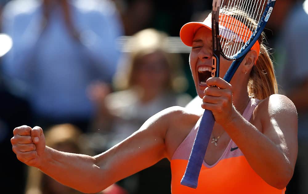 Russia's Maria Sharapova reacts as she defeats Canada's Eugenie Bouchard during their semifinal match of the French Open tennis tournament at the Roland Garros stadium, in Paris, France.
