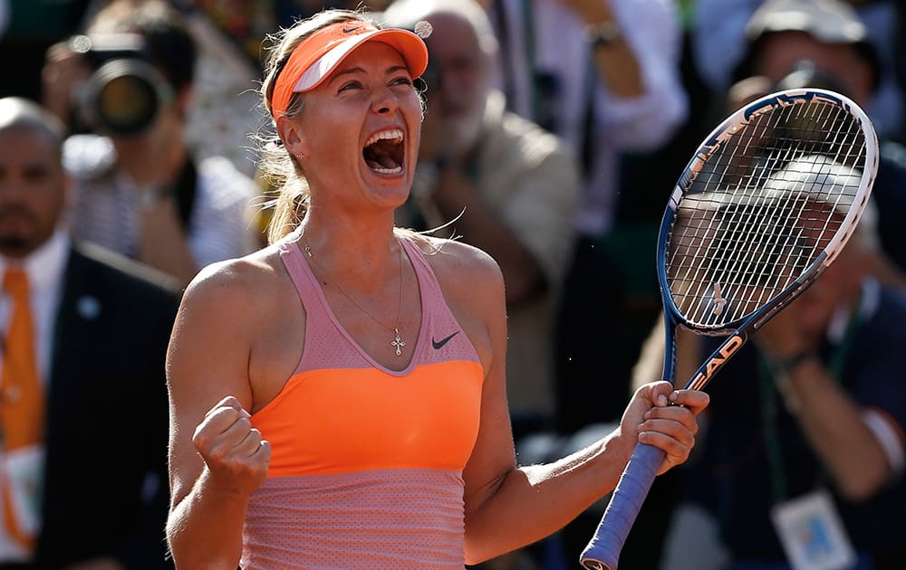 Russia's Maria Sharapova celebrates winning the final of the French Open tennis tournament against Romania's Simona Halep at the Roland Garros stadium, in Paris, France.