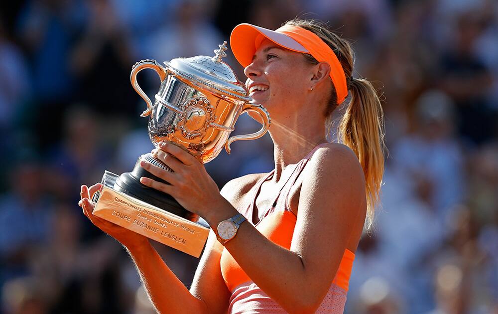 Russia's Maria Sharapova holds the trophy after winning the final of the French Open tennis tournament against Romania's Simona Halep at the Roland Garros stadium, in Paris, France.