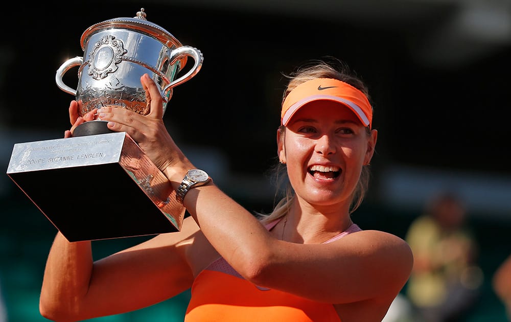 Russia's Maria Sharapova holds the trophy after winning the final of the French Open tennis tournament against Romania's Simona Halep at the Roland Garros stadium, in Paris, France.