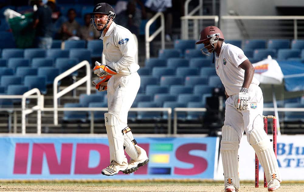 New Zealand's wicket keeper BJ Watling, left, jumps as appeals successfully for the LBW of West Indies' Shivnarine Chanderpaul for 24 runs during the second innings on the fourth day of their first cricket Test match in Kingston, Jamaica.