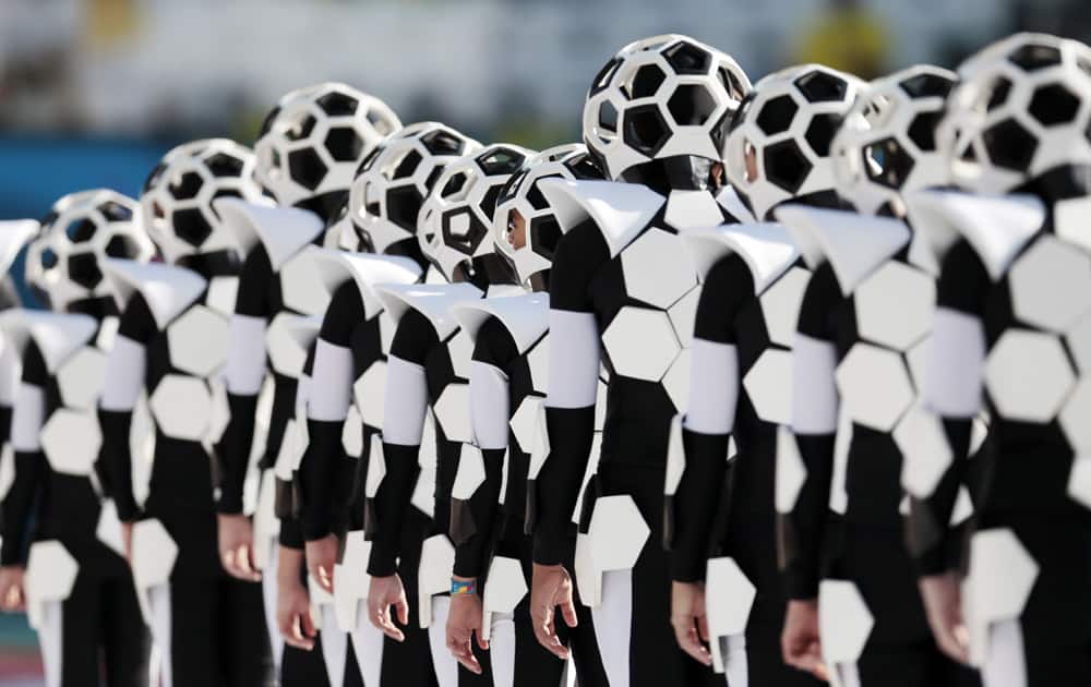 Actors perform during the opening ceremony before the group A World Cup soccer match between Brazil and Croatia, the opening game of the tournament, in the Itaquerao Stadium in Sao Paulo, Brazil.