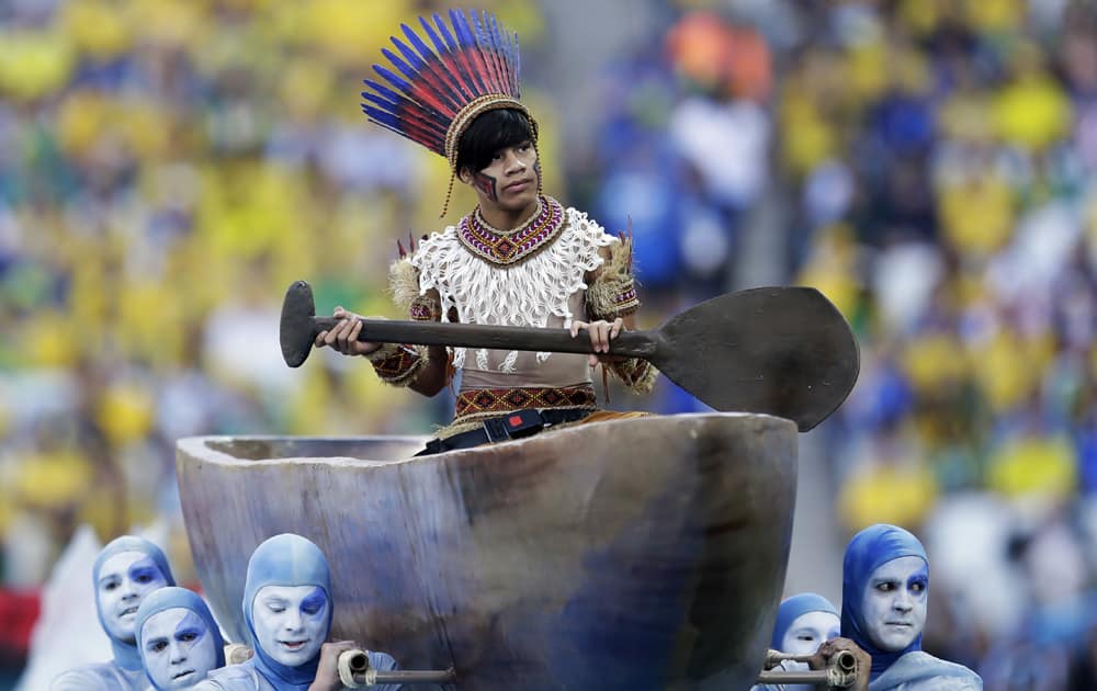 Actors perform during the opening ceremony before the group A World Cup soccer match between Brazil and Croatia, the opening game of the tournament, in the Itaquerao Stadium in Sao Paulo, Brazil.