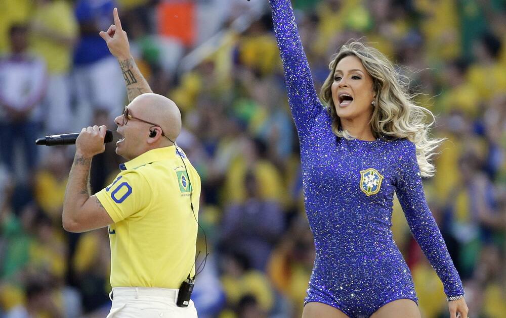 Rapper Pitbull, left, and Brazilian singer Claudia Leitte perform during the opening ceremony ahead of the group A World Cup soccer match between Brazil and Croatia, the opening game of the tournament, in the Itaquerao Stadium in Sao Paulo, Brazil.