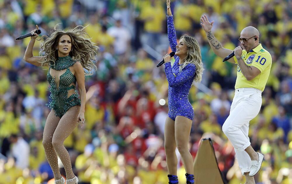 US singer Jennifer Lopez, left, rapper Pitbull and Brazilian singer Claudia Leitte perform during the opening ceremony ahead of the group A World Cup soccer match between Brazil and Croatia, the opening game of the tournament, in the Itaquerao Stadium in Sao Paulo, Brazil.