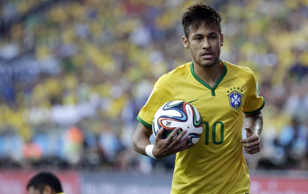 Brazil's Neymar holds the ball during the group A World Cup soccer match between Brazil and Croatia, the opening game of the tournament, in the Itaquerao Stadium in Sao Paulo, Brazil.