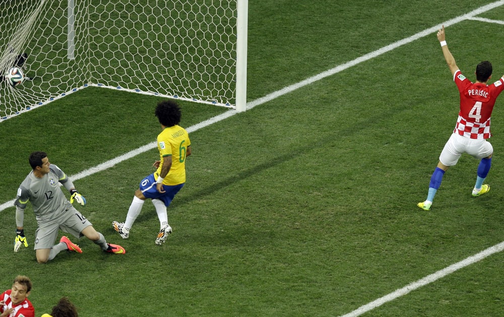 Croatia's Ivan Perisic (4) celebrates as Brazil's Marcelo (6) scores an own goal during the group A World Cup soccer match between Brazil and Croatia, the opening game of the tournament, in the Itaquerao Stadium in Sao Paulo, Brazil.