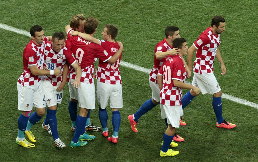 Croatia players celebrate after Brazil's Marcelo scored an own goal during the group A World Cup soccer match between Brazil and Croatia, the opening game of the tournament, in the Itaquerao Stadium in Sao Paulo, Brazil.