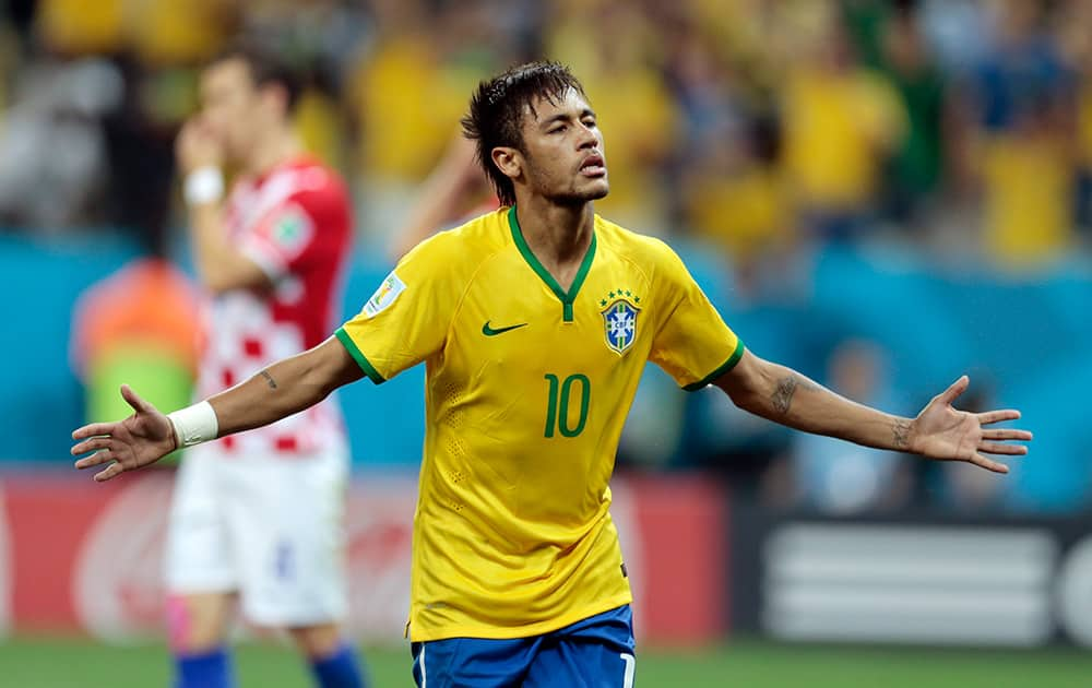 Brazil's Neymar celebrates his second goal on a penalty kick during the group A World Cup soccer match between Brazil and Croatia, the opening game of the tournament, in the Itaquerao Stadium in Sao Paulo, Brazil