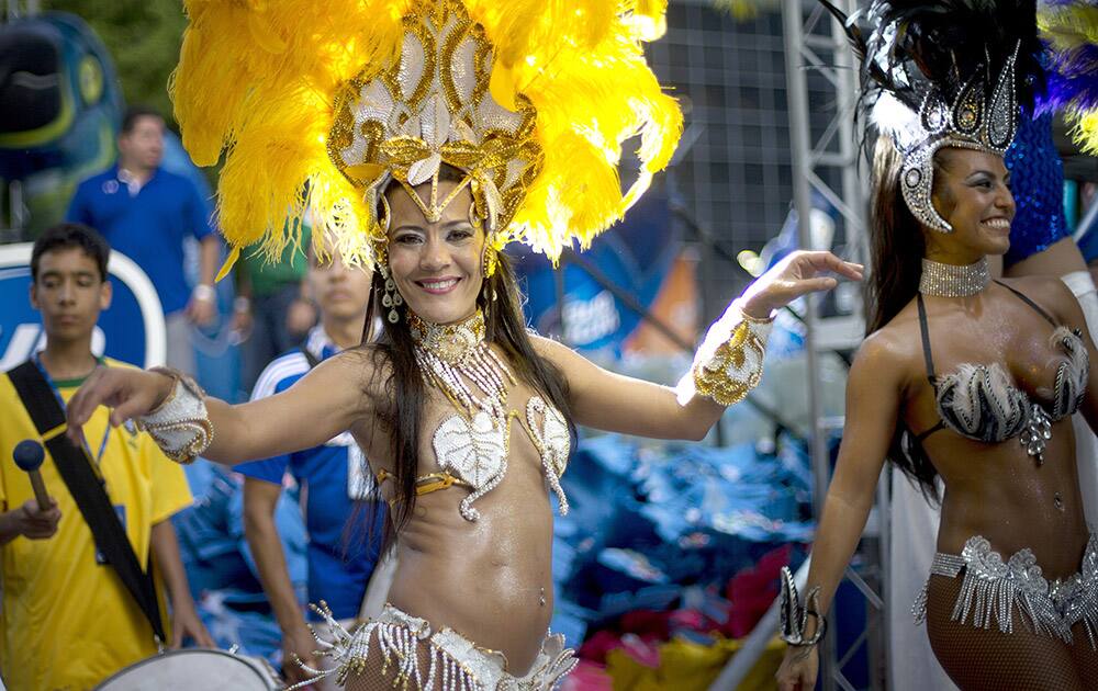 Brazilian samba dancers perform after the World Cup soccer match between Brazil and Croatia, at the Kukaramakara cafe block party in Miami.