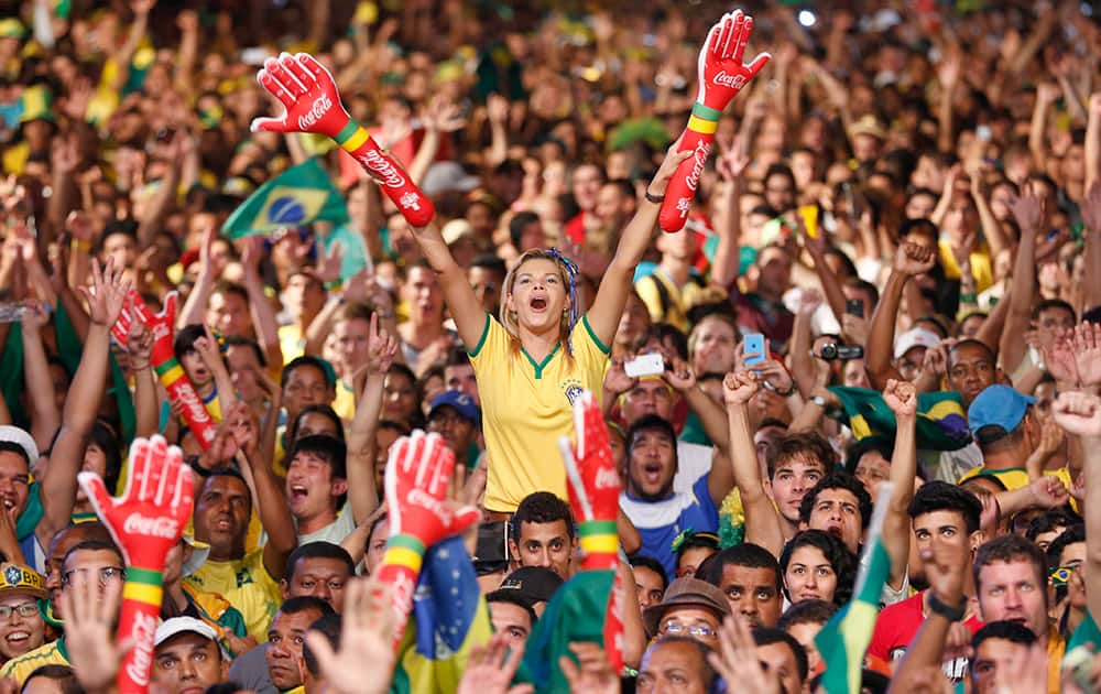 A Brazilian fan shouts as she watches the 2014 soccer World Cup opening game between Brazil and Croatia at the Fan Fest complex in Recife, Brazil.