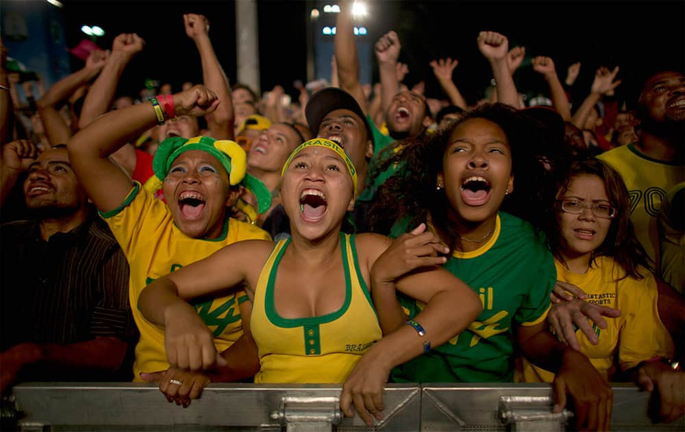 Fans celebrate after Brazil scored the second goal against Croatia during the opening match of the World Cup in Sao Paulo, Brazil.