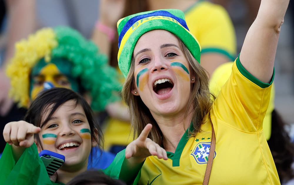 Fans cheer before the start of the group A World Cup soccer match between Brazil and Croatia, the opening game of the tournament, in the Itaquerao Stadium in Sao Paulo.