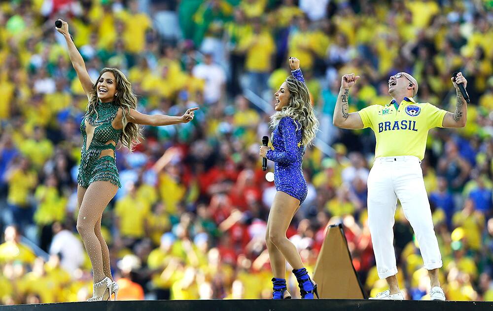 US singer Jennifer Lopez, rapper Pitbull and Brazilian singer Claudia Leitte perform during the opening ceremony ahead of the group A World Cup soccer match between Brazil and Croatia, the opening game of the tournament, in the Itaquerao Stadium in Sao Paulo, Brazil,