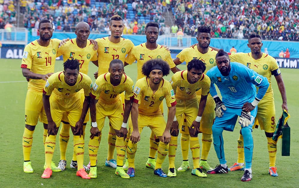 The Cameroon team pose for a photo ahead of the group A World Cup soccer match between Mexico and Cameroon in the Arena das Dunas in Natal, Brazil.