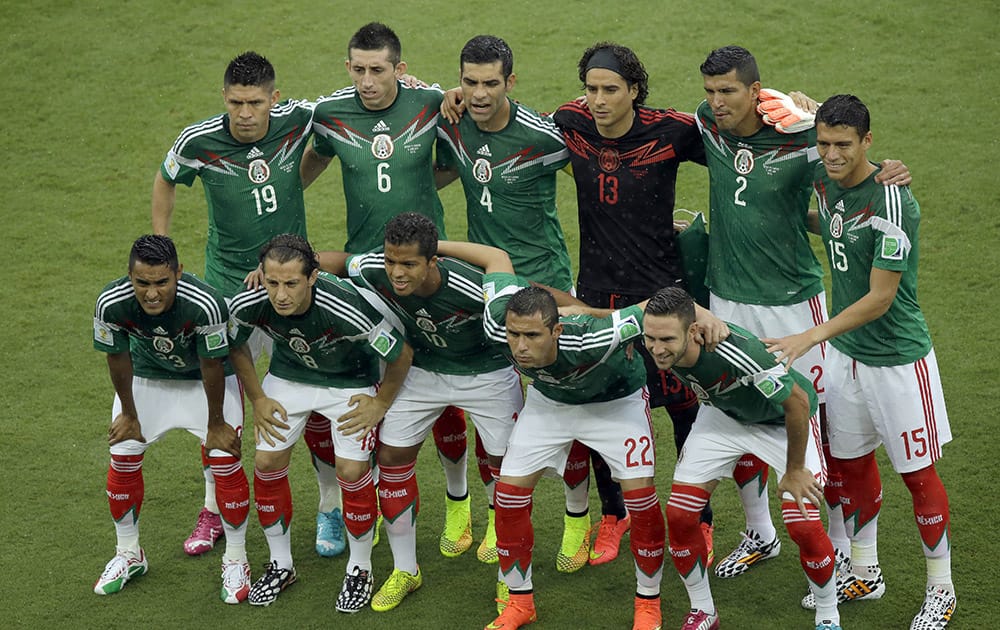 Mexico's team poses for photos prior to the group A World Cup soccer match between Mexico and Cameroon in the Arena das Dunas in Natal, Brazil.