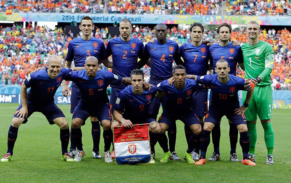 The Netherlands team pose for a photo before their group B World Cup soccer match between Spain and the Netherlands at the Arena Ponte Nova in Salvador, Brazil.