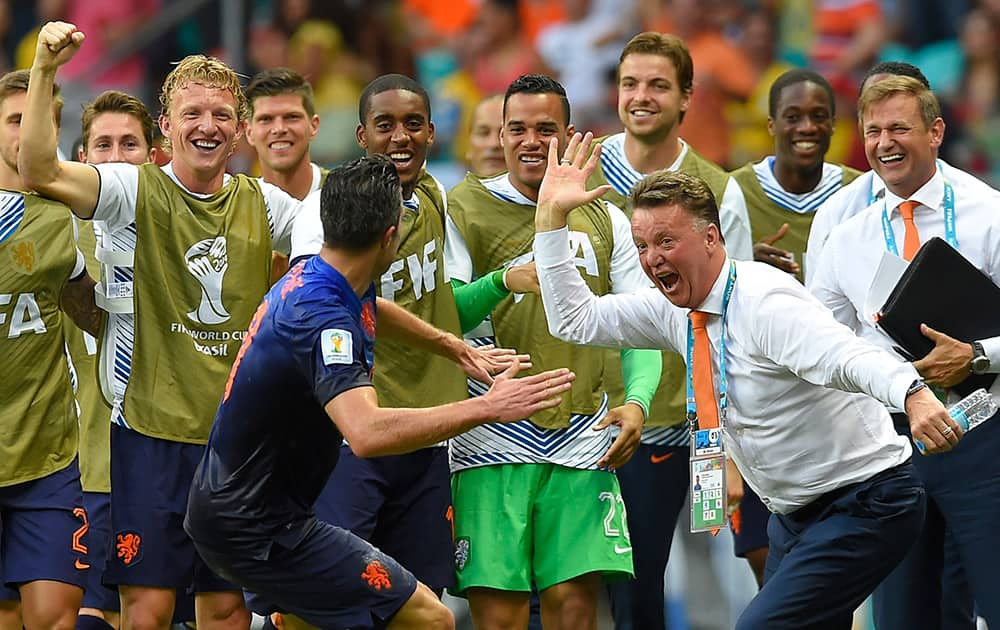 Netherlands' Robin van Persie celebrates with Netherlands' head coach Louis van Gaal after scoring a goal during the group B World Cup soccer match between Spain and the Netherlands at the Arena Ponte Nova in Salvador, Brazil.