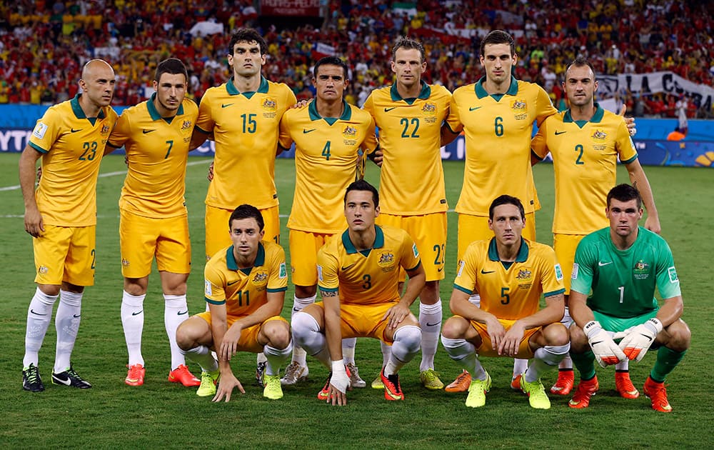 The Australian team poses for a photo before the group B World Cup soccer match between Chile and Australia in the Arena Pantanal in Cuiaba, Brazil.