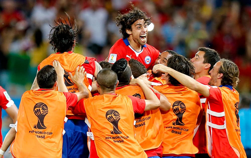 Chile's Jorge Valdivia, top center, celebrates after scoring his side's second goal during the group B World Cup soccer match between Chile and Australia in the Arena Pantanal in Cuiaba, Brazil.