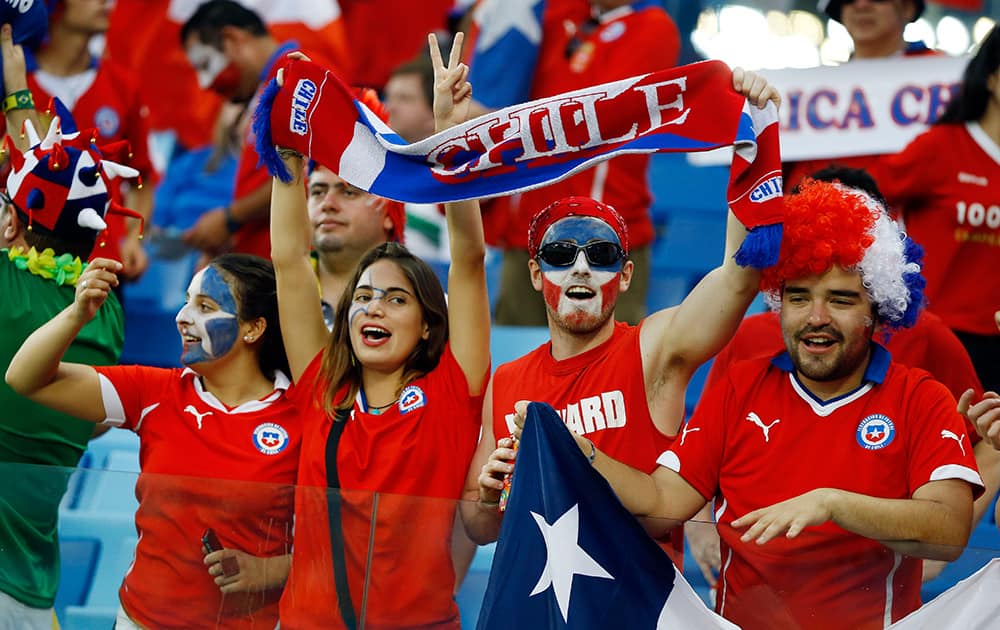 Chilean fans cheer before the start of the group B World Cup soccer match between Chile and Australia in the Arena Pantanal in Cuiaba, Brazil.