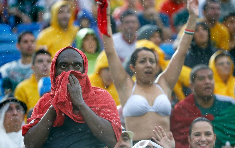 Spectators watch the group A World Cup soccer match between Mexico and Cameroon in the Arena das Dunas in Natal, Brazil.