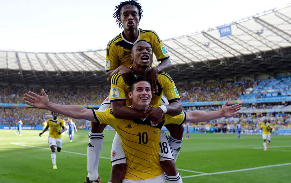 Colombia's James Rodriguez (10) celebrates with his teammates after scoring his side's third goal during the group C World Cup soccer match between Colombia and Greece at the Mineirao Stadium in Belo Horizonte, Brazil.