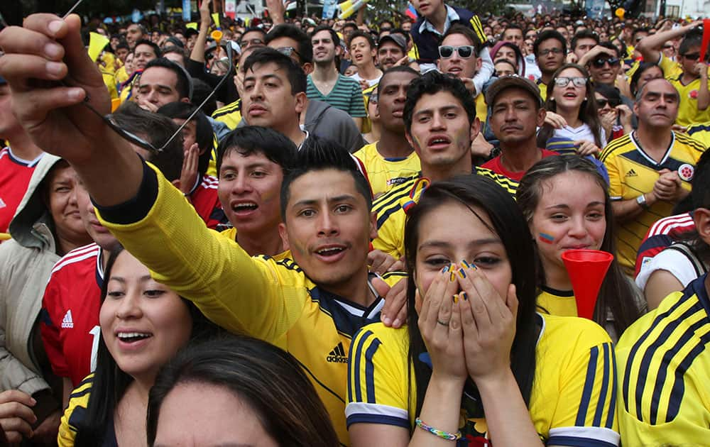 Colombia soccer fans cheer during their team's soccer World Cup game against Greece in Bogota, Colombia. Colombia defeated Greece 3-0.