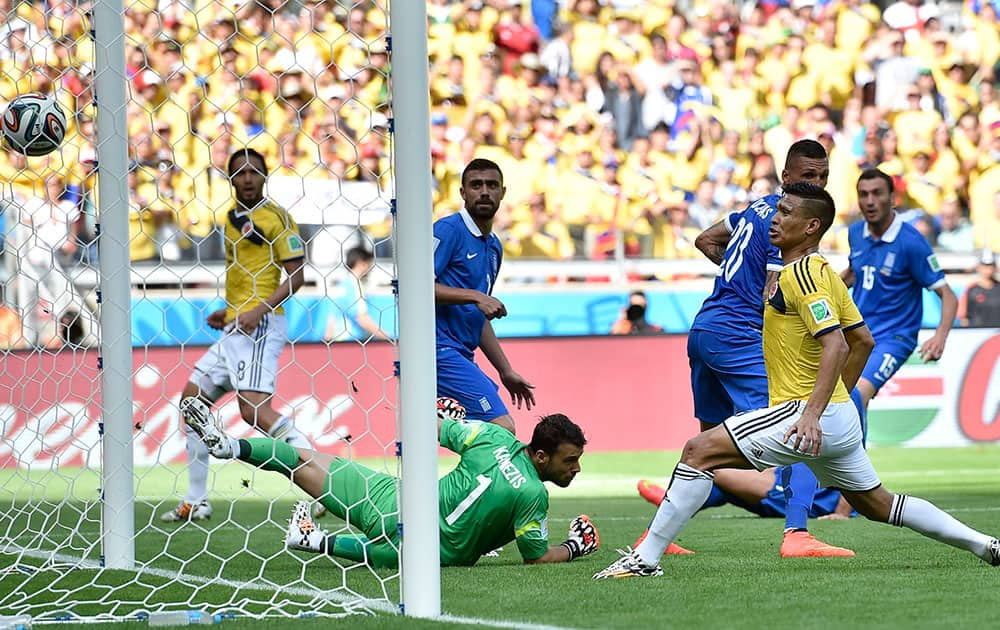 Colombia's Teofilo Gutierrez scores his side's 2nd goal during the group C World Cup soccer match between Colombia and Greece at the Mineirao Stadium in Belo Horizonte, Brazil.